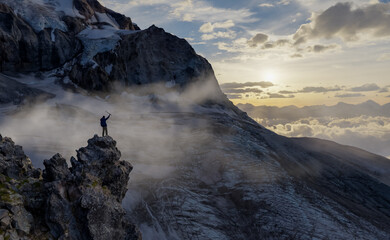 Adventurer Standing on Misty Mountain Summit During Sunrise, 3D Rendering