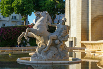 Exploring the beauty of Fonte Luminosa in Lisbon, Portugal, highlighting its intricate sculpture and serene surroundings at sunset