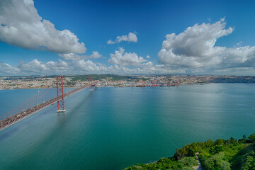 Stunning view of Lisbon from Cristo Rei overlooking the Tagus River and the 25 de Abril Bridge on a clear day