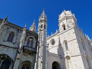 Exploring the architectural beauty of Mosteiro dos Jeronimos in Belem, Lisbon during a clear sunny day