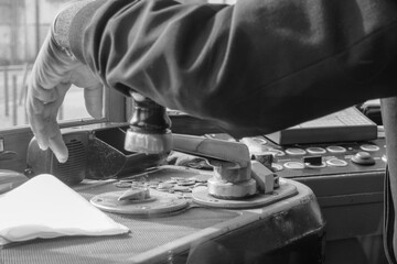 Operator managing Lisbon tram line with focus on detailed controls during a journey through the city