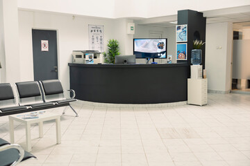 Modern hospital lobby with empty seats for patients and families awaiting appointments or...