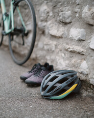 Helmet is laying on the ground next to a bicycle