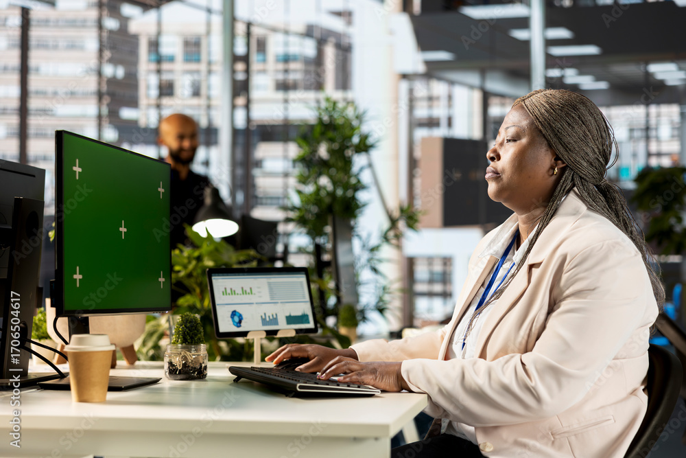 Poster african american project manager working at desk next to copy space display, using performance metri