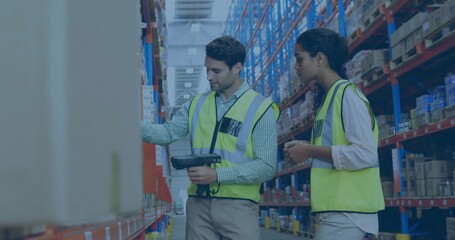 Two workers in neon safety vests scanning boxes on racks in warehouse aisle with handheld scanner