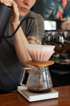 Slow coffee brewing process with filter cone and kettle