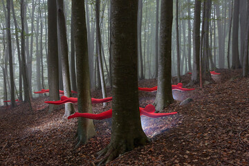 Red-suited figures floating through misty forest
