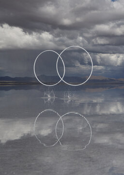 Two rings splashing on reflective salt flat