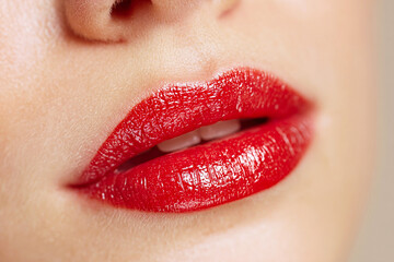 Fototapeta premium Vibrant red lips, close-up, glossy finish, sensual woman's mouth, perfect makeup, beauty portrait, fashion and cosmetic concept, skincare, glamorous, luscious, feminine expression, studio shot, all
