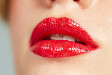 Fototapeta premium Close-up of luscious red lips, shiny gloss, female beauty, sensual makeup, vibrant red color, perfect for cosmetics advertising, fashion, glamour, elegant, seductive look, women's beauty, natural l