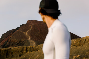 Out-of-focus runner dmiring a volcano before climbing it