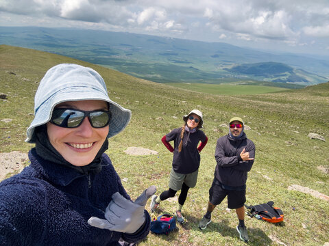Hiker taking selfie of her friends and herself in the mountains