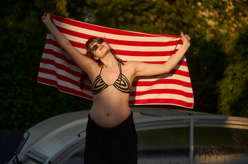Confident pregnant woman enjoying summer sun
