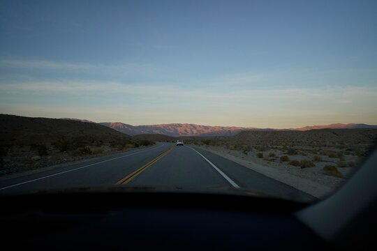 Scenic Road Trip Through Desert Landscape at Dusk