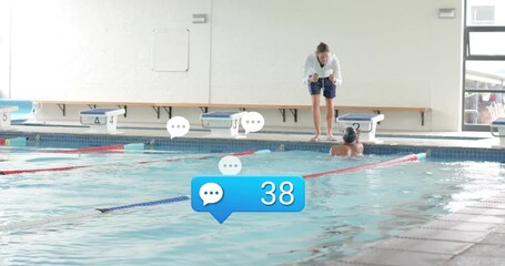 Swimmer touching lane two and pushing off coach timing swim training with comment bubbles updating - Powered by Adobe