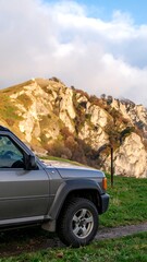 SUV parked at the base of a mountain range