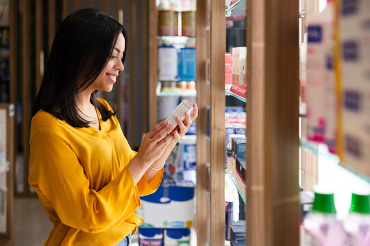 Woman shopping for products at store shelf