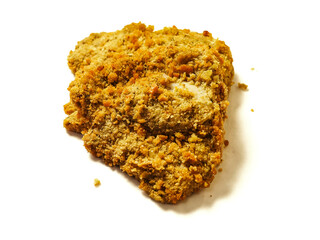 Fine breaded chicken breast fillet on white background. Classic poultry product. Uncooked meat covered with golden breadcrumbs.