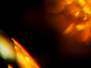 Colorful light leaks on black background for design and special effects. Retro film look. Abstract colorful light beams.