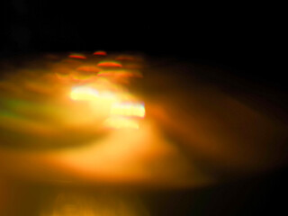 Colorful light leaks on black background for design and special effects. Retro film look. Abstract colorful light beams.