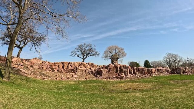 Red Quartzite Ridge with Trees and Green Grass, Looping Pan Across Scenic Landscape, Sioux Falls, Falls Park, South Dakota