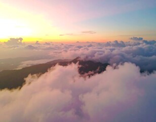 Sunrise over mountaintops shrouded in clouds