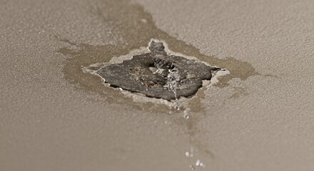 Water damage on ceiling with exposed plaster and dripping water  