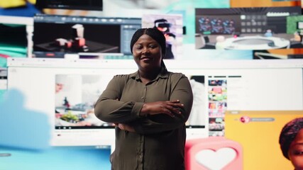 Portrait of pleased user enjoying unlimited entertainment in modern digital environment. Happy african american woman in front of giant digital wall streaming online videos content, camera A - Powered by Adobe