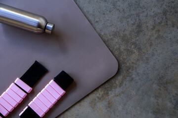 Metal Bottle and Adjustable Weights on Exercise Mat