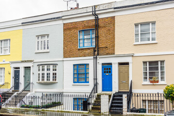 Traditional terraced houses with flights of stairs leading to the front doors on a rainy winter day