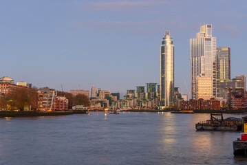Fototapeta premium London skyline as seen form Battersea Power Station riverside walk under clear sky at dusk in winter