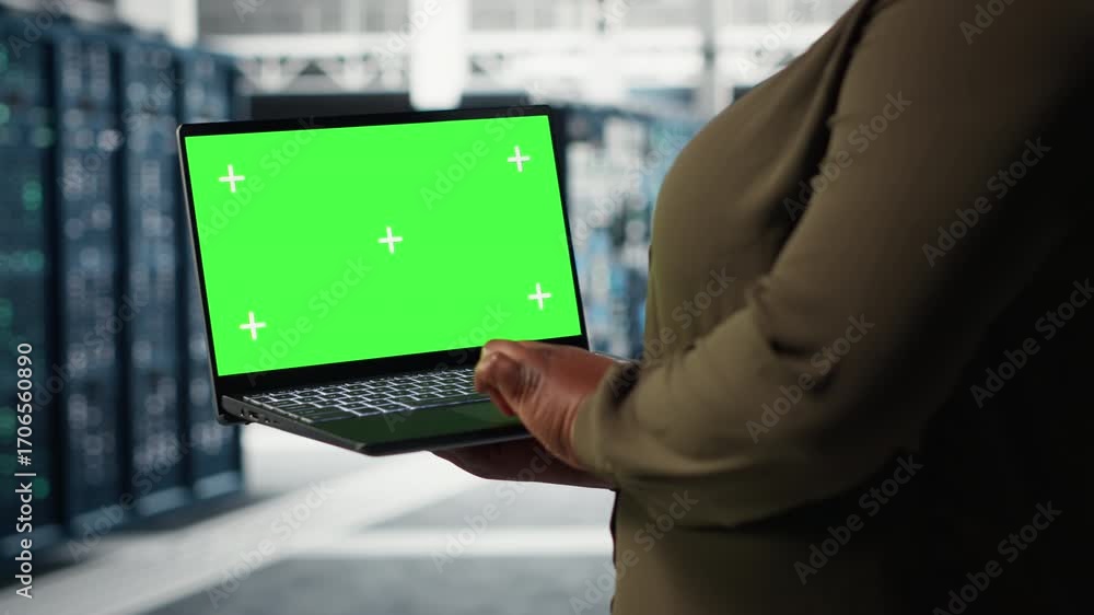 Poster data center expert monitors data center metrics on isolated screen laptop to enhance operational eff