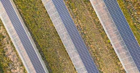 Aerial view of modern solar greenhouses with photovoltaic panel roofs, sustainable agriculture and renewable energy integration for eco farming and clean power production