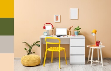 Inventor's workplace with laptop and tablet computer near beige wall. Different color patterns