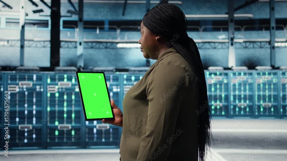 Leinwandbilder software developer at work using green screen tablet in data center to check hardware for system sta