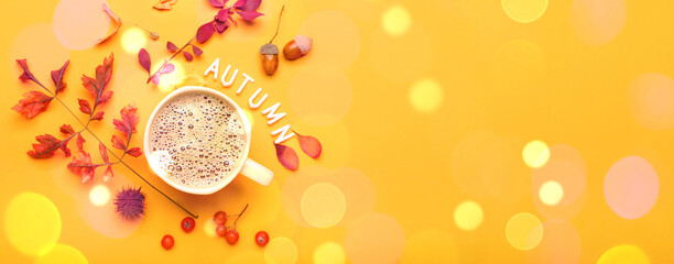 Autumn composition with cup of coffee and text AUTUMN on color background © Pixel-Shot