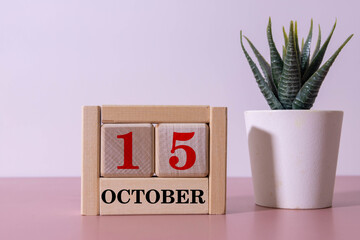 Wooden calendar with the date October 15. Monthly calendar