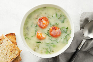 Portuguese style soup Caldo Verde with bread on gray background close up