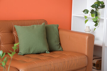 Brown sofa with green cushions in living room