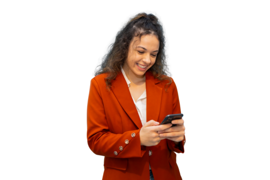Professional businesswoman wearing sleek red suit, smiling confidently while working on smartphone against transparent backdrop