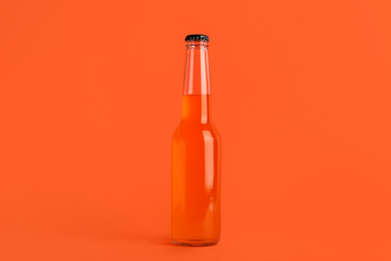 Bottle of soda drink on orange background