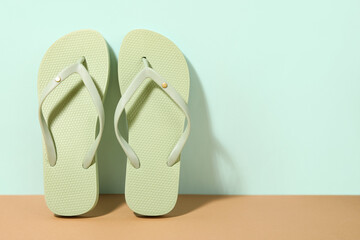 Stylish green beach shoes on blue background, closeup