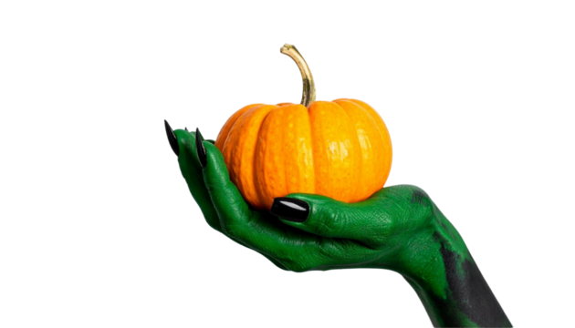A vibrant orange pumpkin resting in a green hand, celebrating halloween. The hand is painted green, featuring black nails
