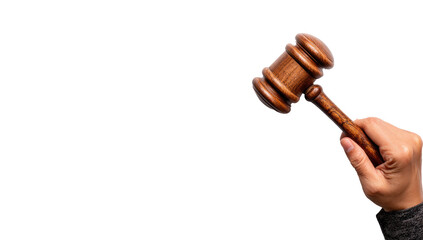 A wooden gavel held in a hand against a black background