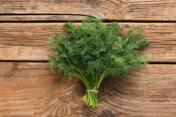 Bunch of fresh green dill on wooden background