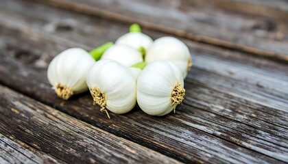 White garlic bulbs on weathered wood