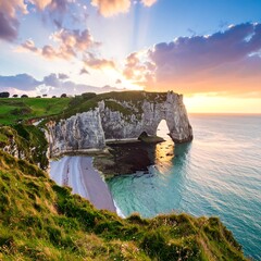 Dramatic coastal landscape at sunset.  A large arching rock formation over a beach.  Vast ocean meets sky
