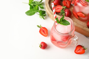 Glass of tasty cold cocktail with strawberry on white background, closeup