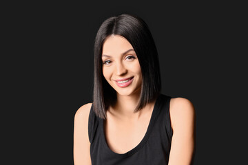 Fototapeta premium Beautiful young woman with short hair on dark background