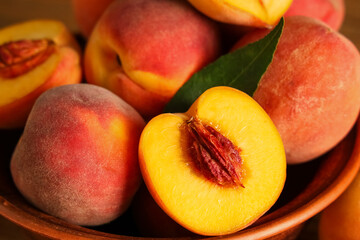 Sweet ripe peaches in bowl, closeup